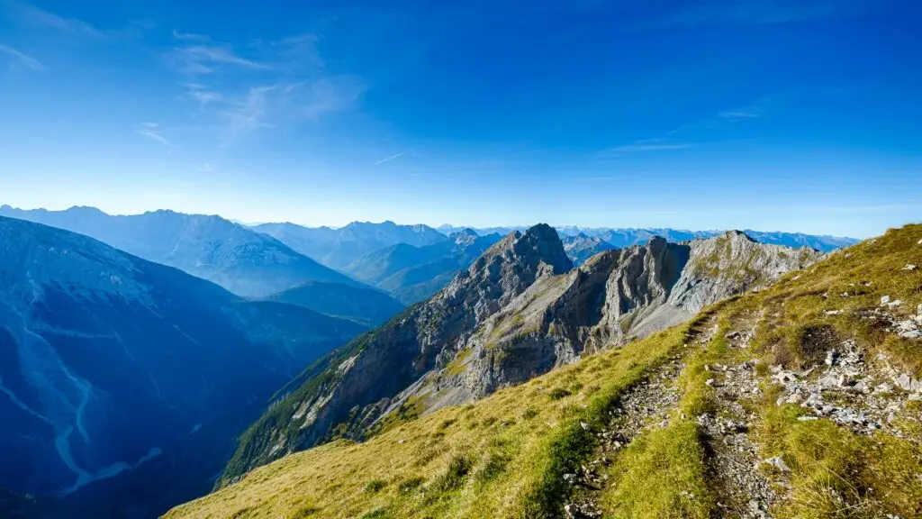 Stunning landscape of the rocky mountains with a vibrant blue sky in Mittenwald, Germany.